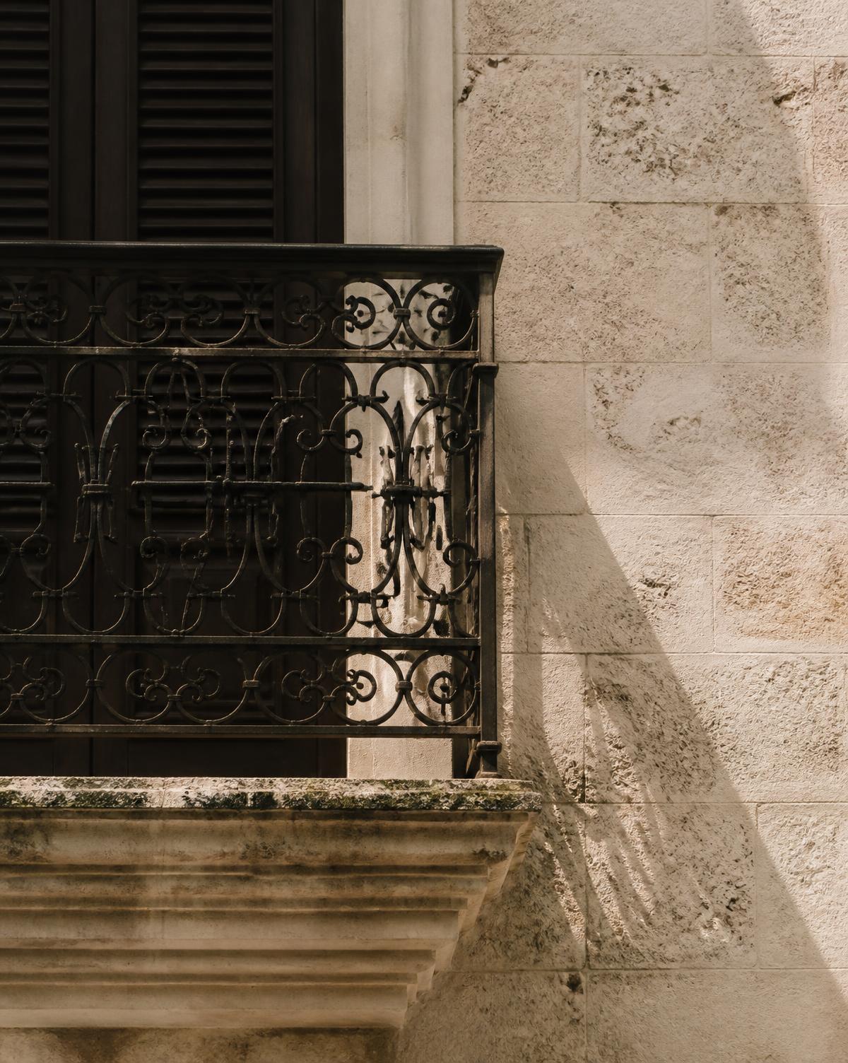 Wrought iron balcony and limestone wall in Old San Juan, Puerto Rico